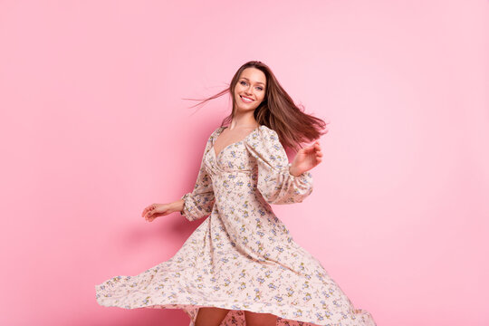 Photo portrait smiling girl dancing in printed dress on weekend summer isolated pastel pink color background - Powered by Adobe