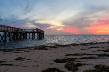 Fototapeta na wymiar Pier on the beach at sunset 