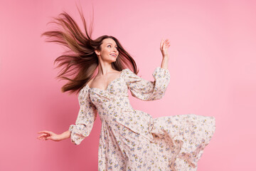 Photo portrait pretty girl wearing floral dress walking in windy weather flying hair looking...