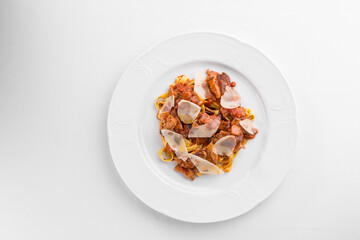 fettuccine pasta with pork and tomato sauce on white plate isolated on white background