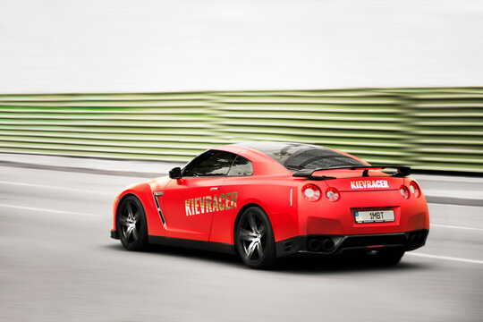 Kiev, Ukraine - June 16, 2021: Red Nissan GT-R R35 supercar in motion. Blurred car. Nissan GT-R at high speed