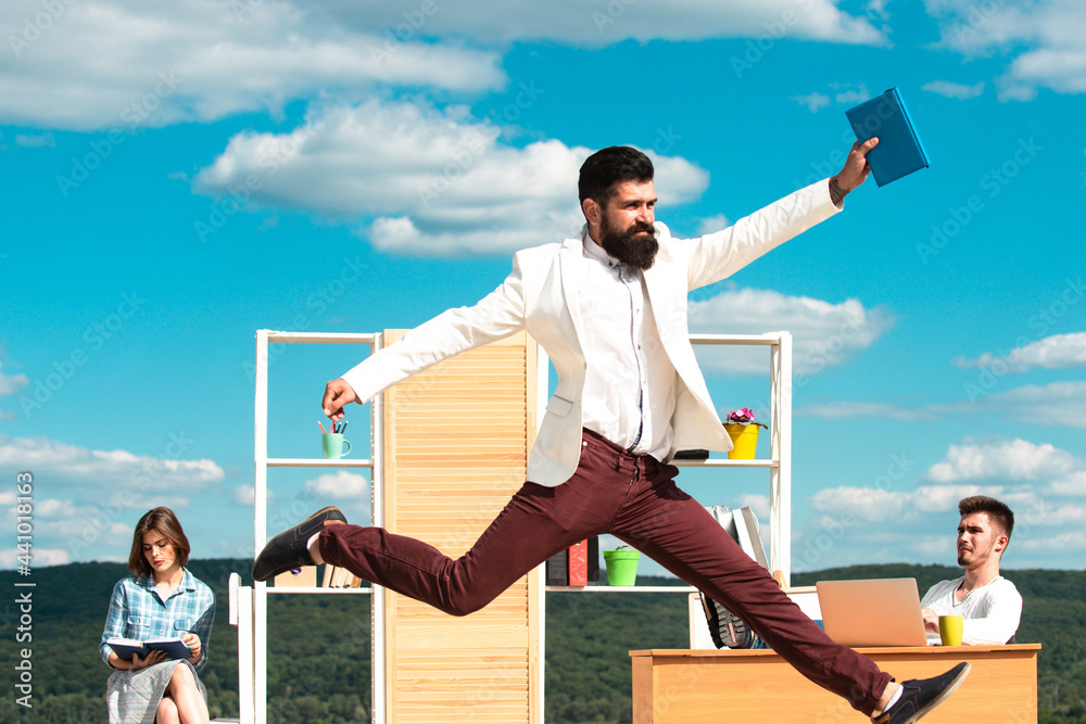 Wall mural businessman jump on background of colleagues. office workers.