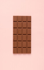 Milk vegan chocolate on a pink background. Minimalism