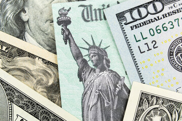 Macro view of the Statue of Liberty on a United States Treasury Check with currency in background. 