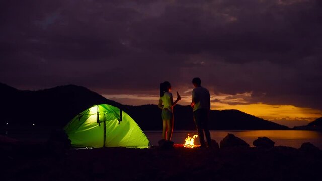 footage 50p frame rate of adventurous couple are setting up campfires and enjoying the beauty of nature.

