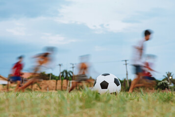 action sport outdoors of diversity of kids having fun playing soccer football for exercise in...