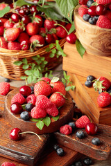 Assorted fresh berries with leaves.