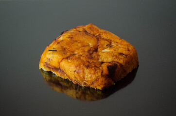 Sliced ​​bread with paprika, piece, photo on a dark surface