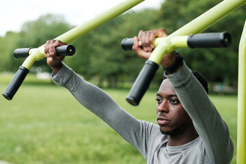 Portrait of black male working out outdoors in a park.