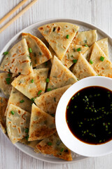 Homemade Scallion Pancakes with Soy Dipping Sauce on a white wooden background, top view. Flat lay, overhead, from above.
