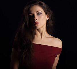 Naklejka premium Beautiful mysterious woman makeup face with wisdom emotional look on dramatic shadow black background with empty copy space. Closeup