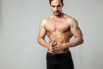 portrait of a handsome man posing with a naked torso on a white background