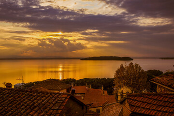 Beautiful sunset over Lake Trasimeno Isola Maggiore (Greater Island) and Isola Minore (Little Island) in Umbria, from Passignano old town