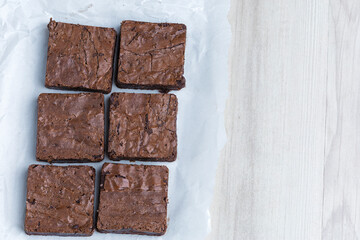 brownie pieces arranged on a wooden base viewed from above with free side area