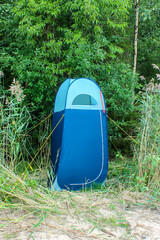 blue high tent without bottom, camp toilet or changing room, Camping shower. Camping travel hiking...