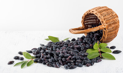honeysuckle berries spilled out of the basket onto the white table