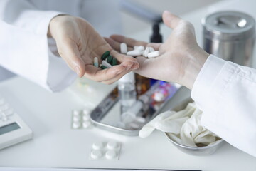 Close up of doctor holding pills