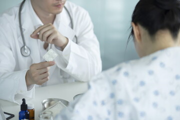 Doctor giving medicine to patient