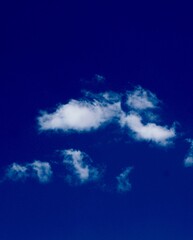 The bright blue sky with the white clouds.