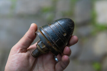 tip from a projectile in his hand
