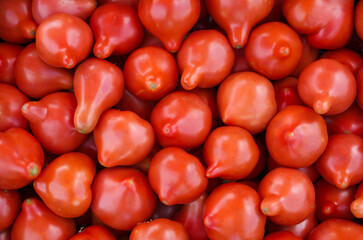 Red ripe juicy tomatoes background.