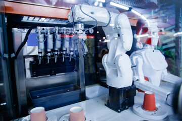 Robot working in industrial food factory packaging ice cream. Concept automated production line