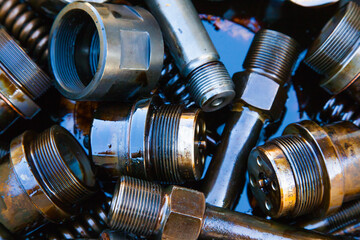 Details of the ship's main engine in oil close-up. Nozzles, bushings, springs and threaded parts.