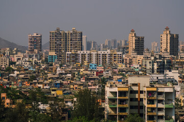Fototapeta na wymiar Panoramic aerial view of polluted, crowded extended suburbs of Navi Mumbai (New Bombay) which have shown an uncontrollable surge in virus cases pandemic.