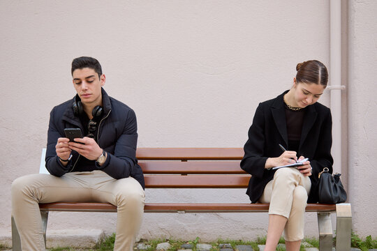 Strangers Sitting On A Bench With Distance