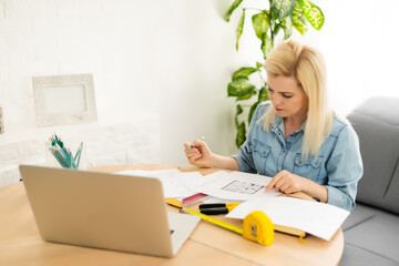 Architect working on blueprint. Architects workplace - architectural project, blueprints, ruler,...