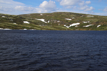 blue waters of the northern lake on the background of the tundra