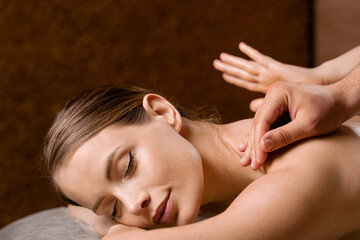 4 hands massage in spa. Two masseurs are making four hands relaxing massage with oil for girl....