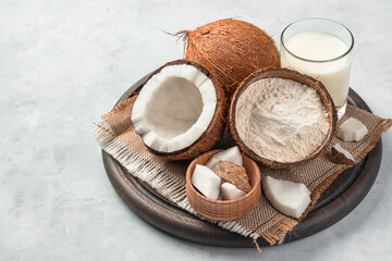 Fresh coconut and coconut products on a gray background.