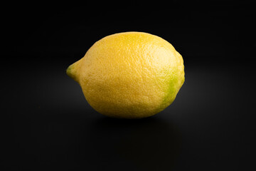 Lemon with dark background up close