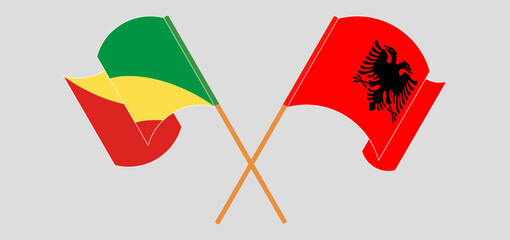 Crossed and waving flags of Republic of the Congo and Albania