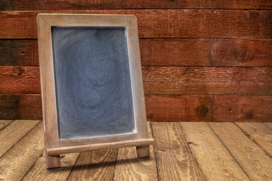 blank blackboard sign on a rustic weathered wood