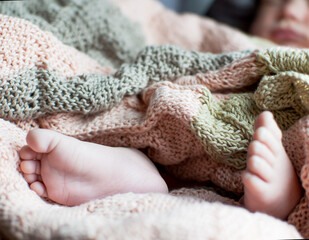 Small tender feet of a newborn baby