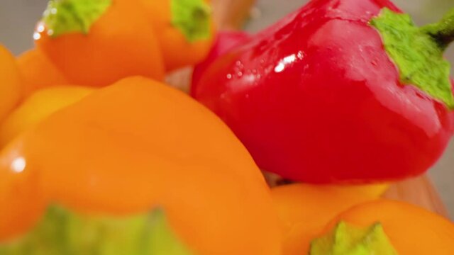 Mini Peppers Pull Back Above on Cutting Board Macro. macro view of mini peppers on a cutting board pulling back above stacked peppers