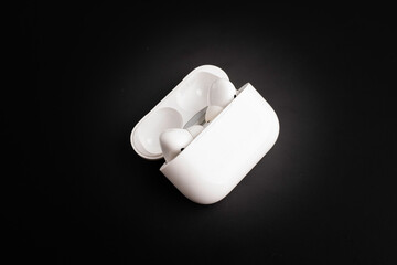 Wireless headphones on dark background.