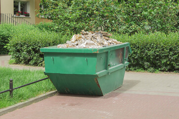 Large metal container with solid household waste