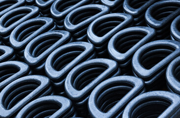 D-shaped steel rings stacked in close-up. Lots of steel rings for securing and securing heavy...