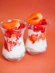 A healthy breakfast is prepared with fresh fruit, yogurt and muesli.