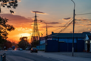 High-voltage power lines over sunset background