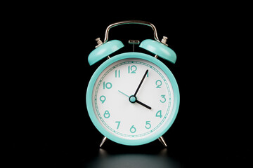 Old clock isolated on black background with space for text. Concept of time