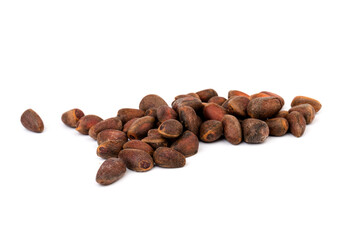 Fresh unpeeled cedar nuts isolated on white background, closeup