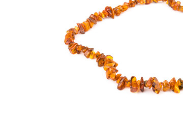 Baltic necklace made of Natural polished transparent honey luxury amber beads with inclusions on white. close up selective soft focus. Space for text