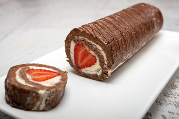 Chocolate Swiss Roll Cake with white cream filling and Strawberry