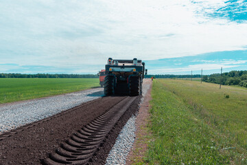 Fototapeta premium Laying of a new road, filling with rubble.