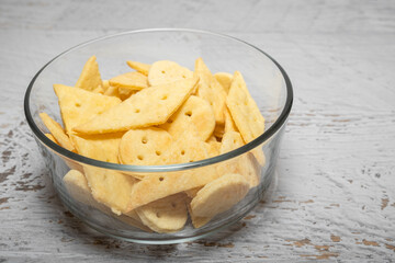 Delicious homemade crackers on white wooden table. Crunchy savory crackers snack idea for kids or adults