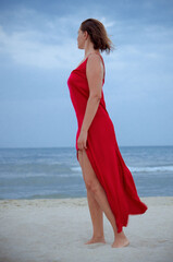 woman in red dress on the beach